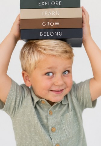 Boy balancing books on his head